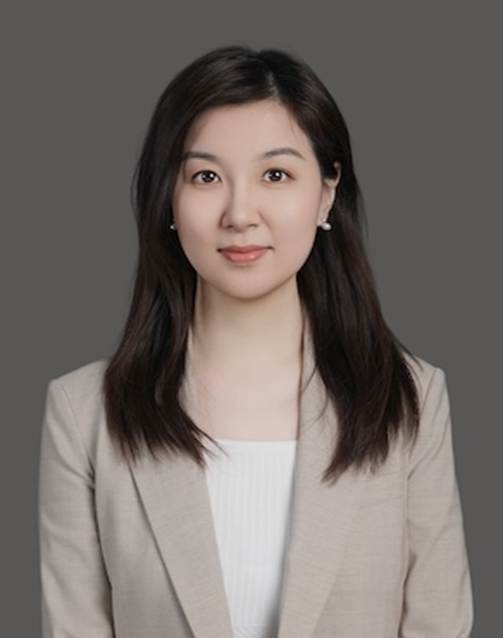 A person with dark hair wearing a beige jacket AI-generated content may be incorrect.